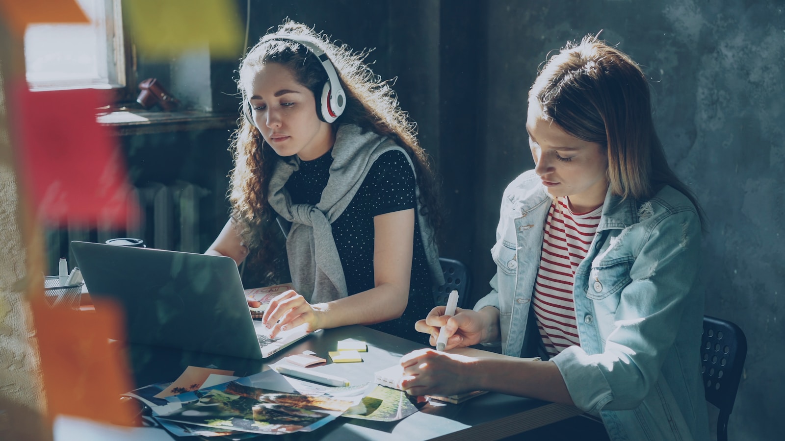 Two young women working on a project together.